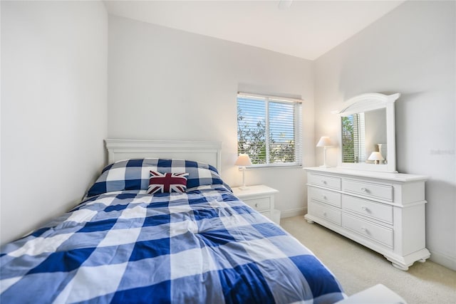 carpeted bedroom with lofted ceiling