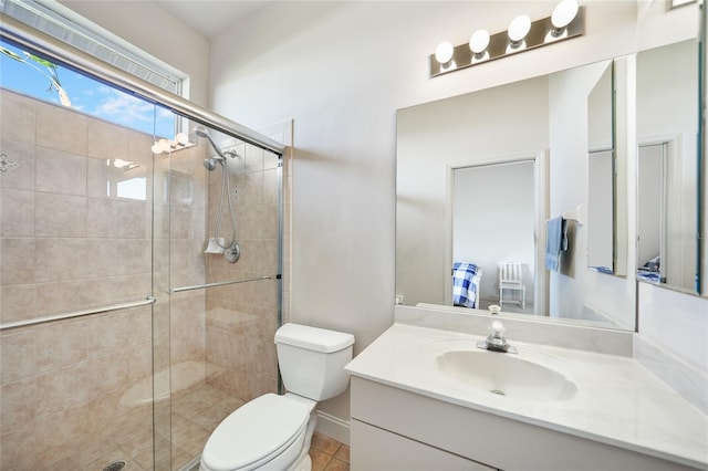 bathroom with tile patterned floors, vanity, an enclosed shower, and toilet