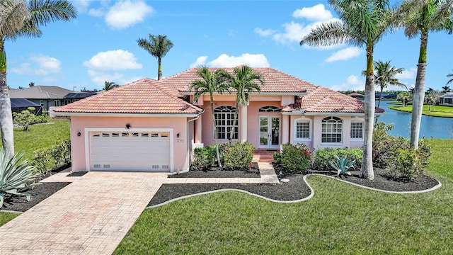 24282 Silver Ln, Punta Gorda, FL 33955 - mediterranean / spanish-style house with french doors, a garage, a tile roof, stucco siding, and decorative driveway