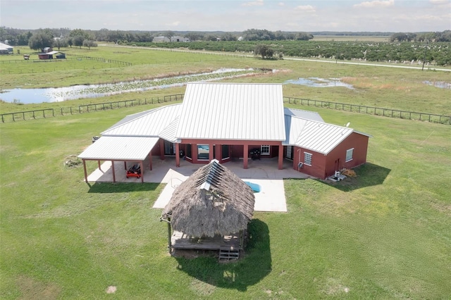 birds eye view of property featuring a water view and a rural view