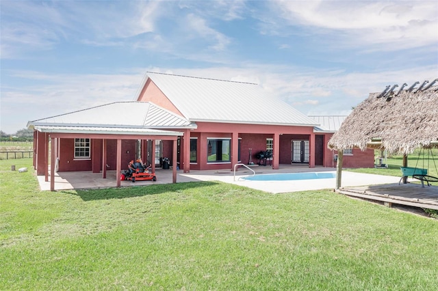 rear view of property with a patio area and a yard