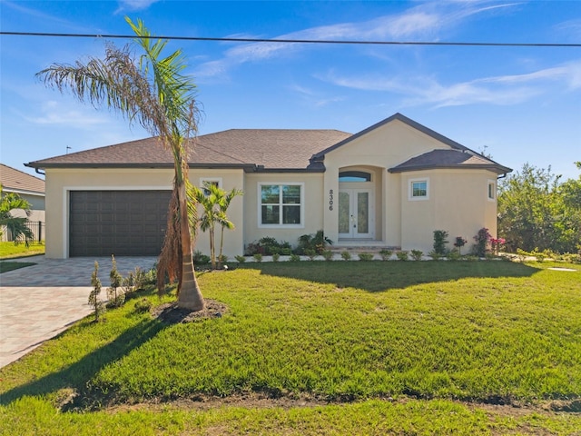 ranch-style house with french doors, a garage, and a front lawn