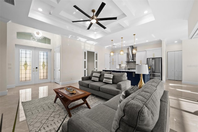 tiled living room featuring a high ceiling, coffered ceiling, french doors, ceiling fan with notable chandelier, and crown molding