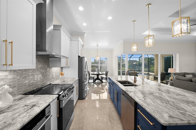 kitchen featuring blue cabinetry, appliances with stainless steel finishes, wall chimney exhaust hood, and sink