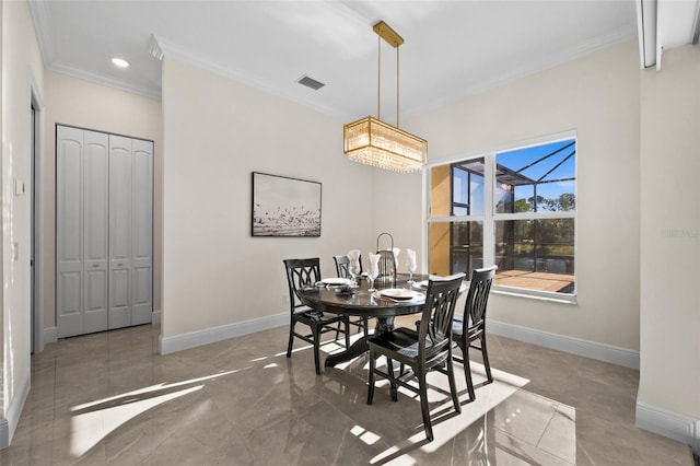 dining area featuring ornamental molding and a chandelier