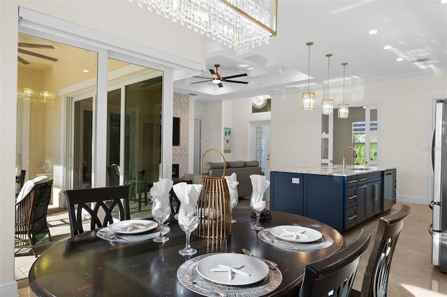 dining space featuring ceiling fan with notable chandelier, sink, beverage cooler, and coffered ceiling