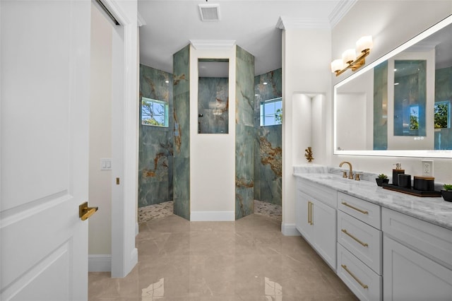 bathroom featuring a tile shower, crown molding, vanity, and a healthy amount of sunlight