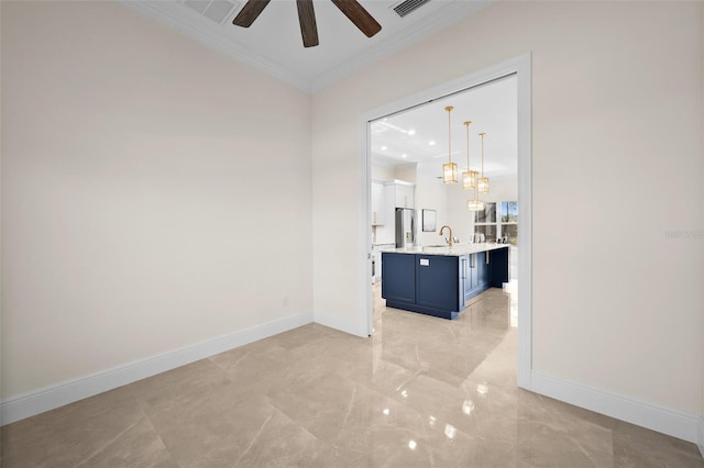 interior space with ceiling fan, crown molding, and sink