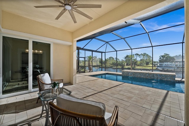 view of pool featuring a water view, a jacuzzi, ceiling fan, a lanai, and a patio area