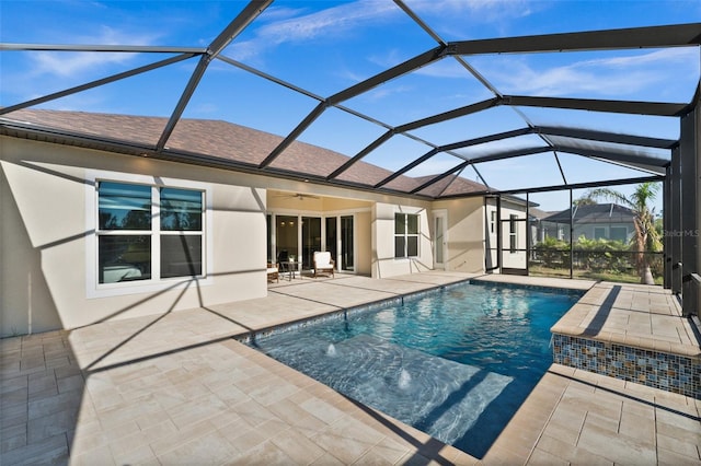 view of pool with pool water feature, a patio area, ceiling fan, and a lanai