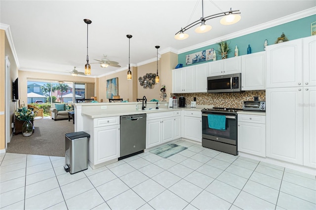 kitchen featuring white cabinetry, ceiling fan, decorative light fixtures, light carpet, and appliances with stainless steel finishes