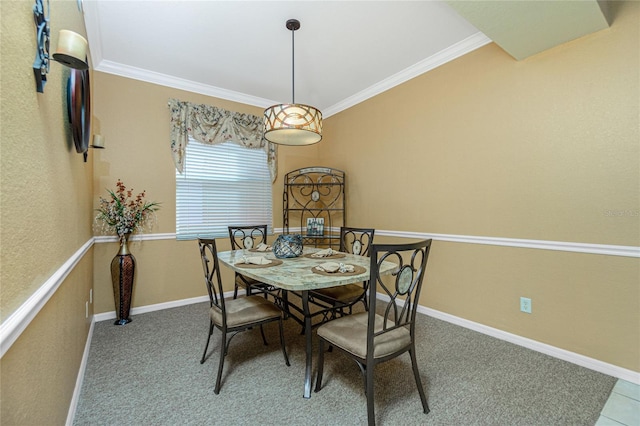 carpeted dining space featuring ornamental molding