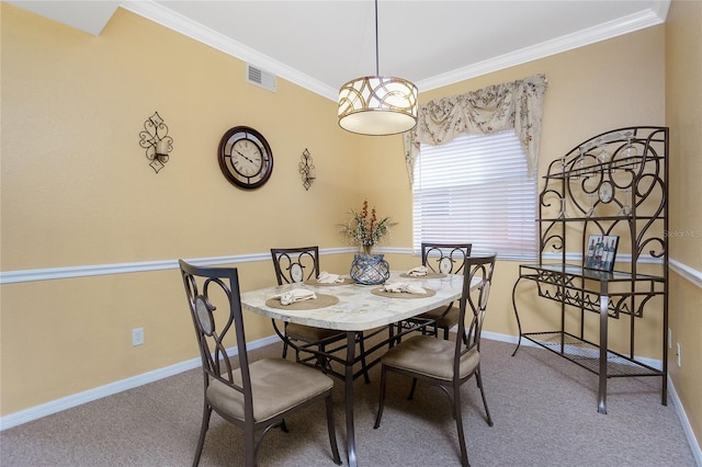 carpeted dining room with crown molding