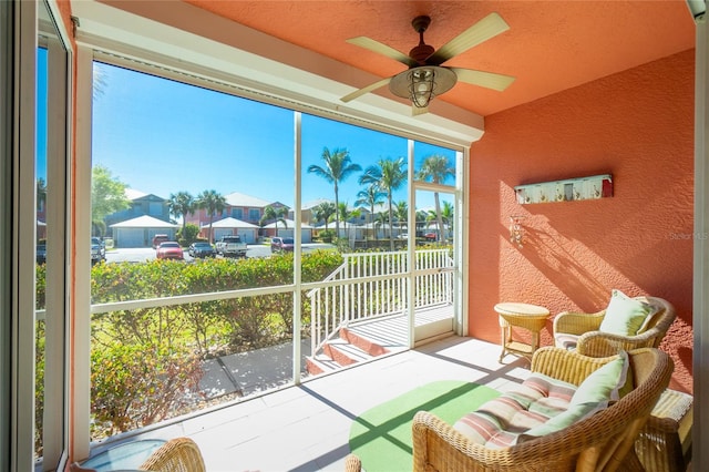 sunroom featuring ceiling fan