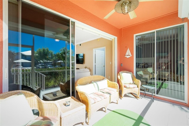 sunroom / solarium featuring ceiling fan