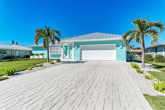 view of front of home featuring a garage and a front lawn