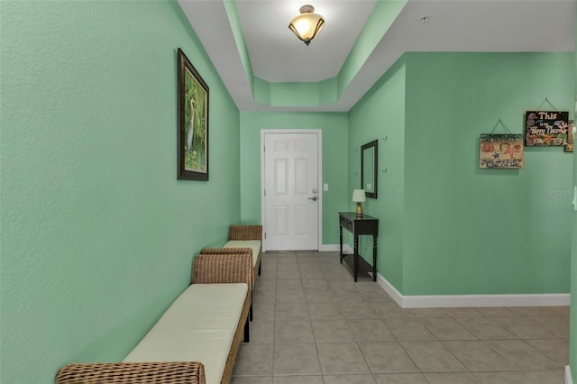 tiled foyer entrance featuring a tray ceiling