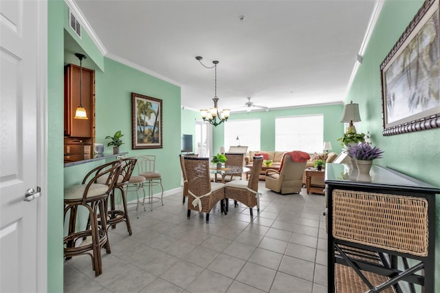 tiled dining room featuring ceiling fan with notable chandelier and crown molding