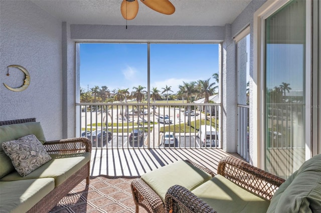 sunroom with ceiling fan and a healthy amount of sunlight