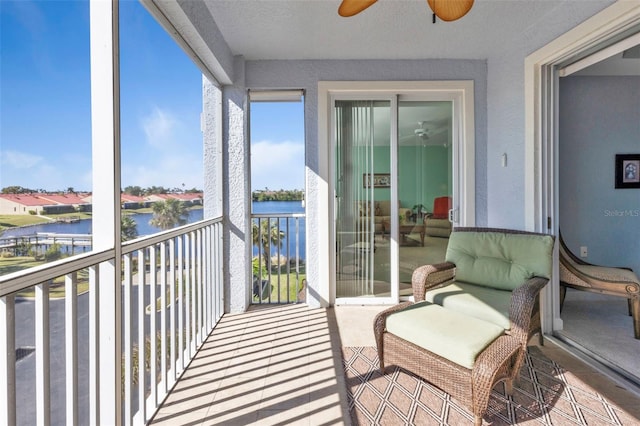 sunroom featuring a water view