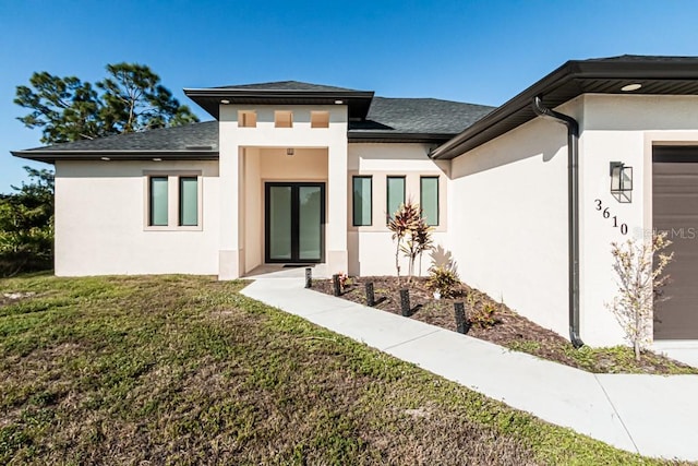 back of property with a garage and a yard