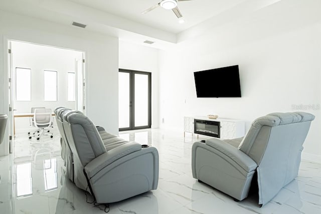 living room with ceiling fan and french doors