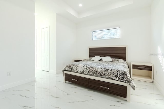 bedroom with a closet and a tray ceiling