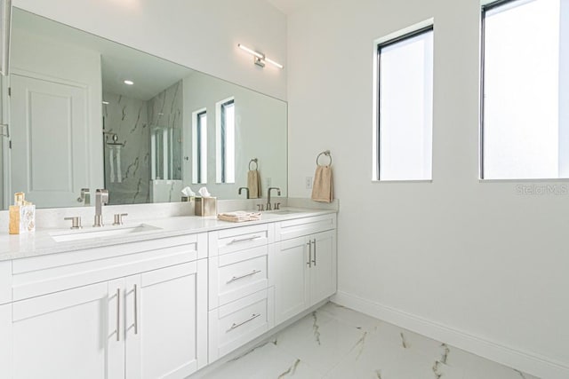 bathroom with vanity and a shower with door