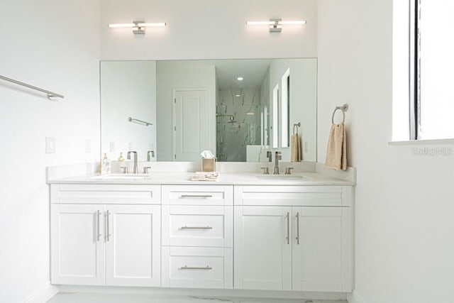 bathroom featuring walk in shower and vanity