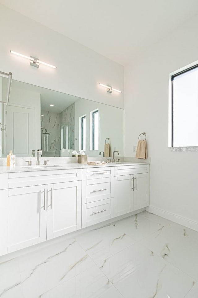 bathroom featuring an enclosed shower and vanity