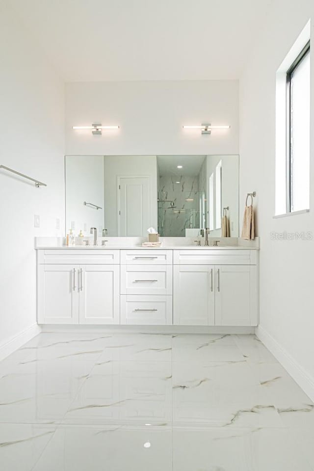 bathroom with walk in shower and vanity