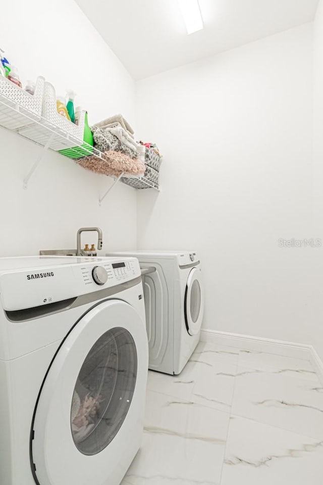 clothes washing area featuring washing machine and clothes dryer