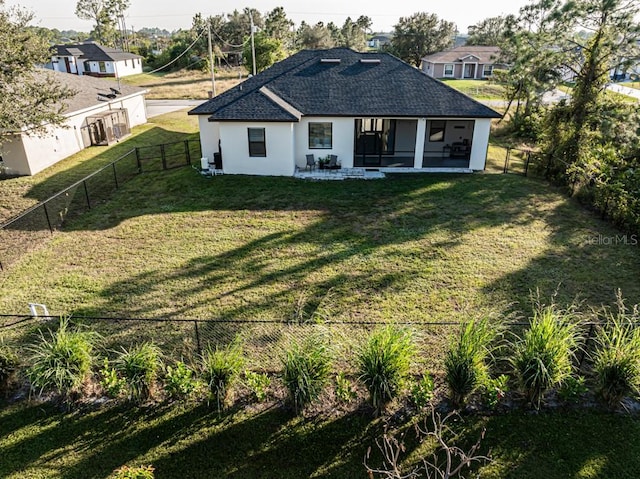 rear view of property featuring a yard