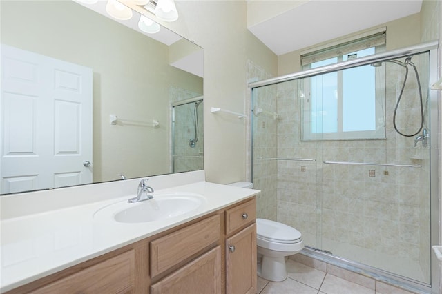 bathroom with tile patterned flooring, vanity, toilet, and a shower with door