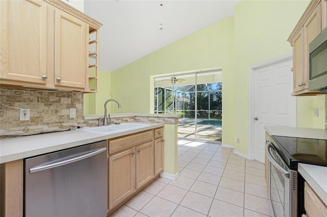 kitchen featuring sink, decorative backsplash, light brown cabinetry, light tile patterned floors, and appliances with stainless steel finishes