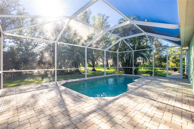 view of pool featuring glass enclosure and a patio area