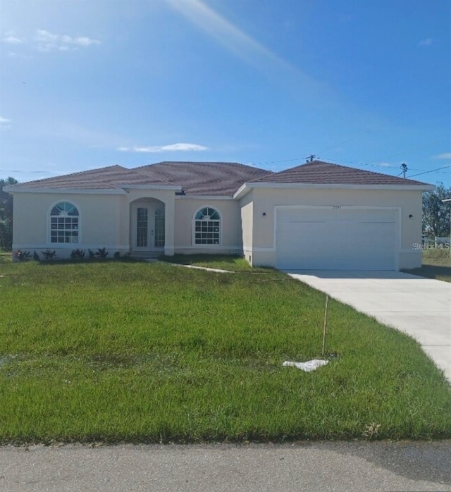 view of front facade with a garage and a front lawn