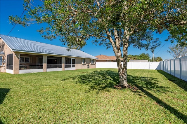 exterior space featuring a yard and a sunroom