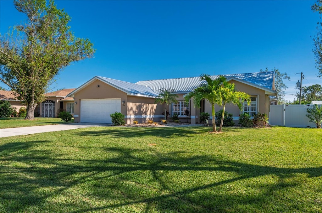 ranch-style house with a garage and a front lawn