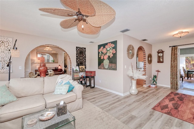 living room with light hardwood / wood-style floors and ceiling fan