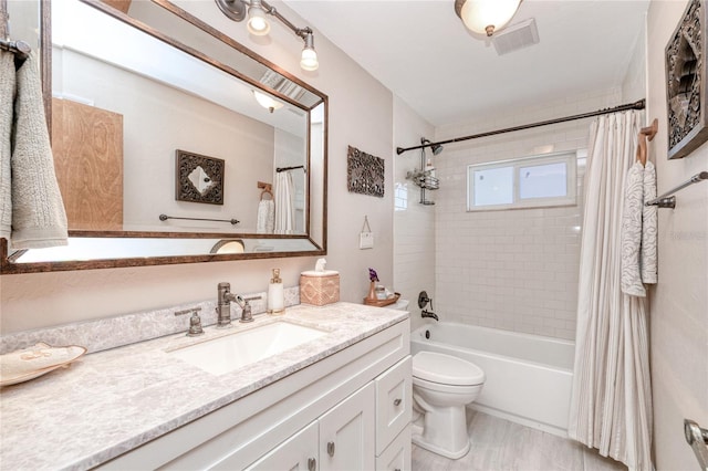 full bathroom with vanity, toilet, and shower / tub combo