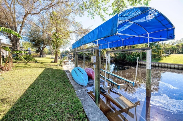 dock area featuring a lawn and a water view