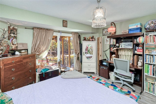 bedroom featuring a textured ceiling and light wood-type flooring