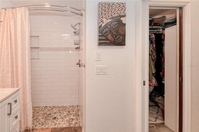 bathroom featuring a shower with curtain and vanity