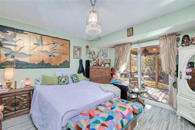 bedroom with light wood-type flooring and access to outside