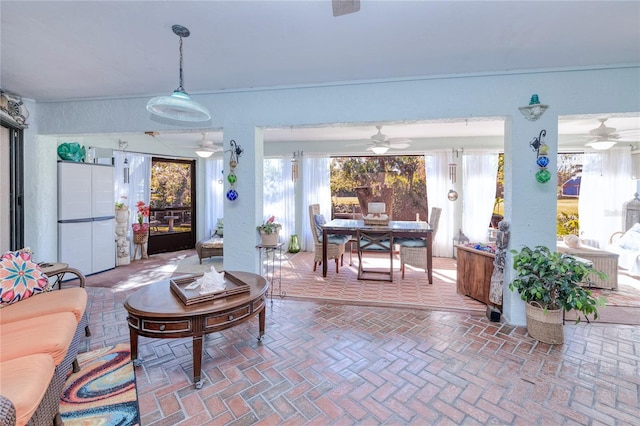 living room featuring a wealth of natural light and ceiling fan