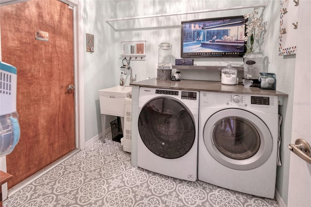 clothes washing area featuring washer and dryer