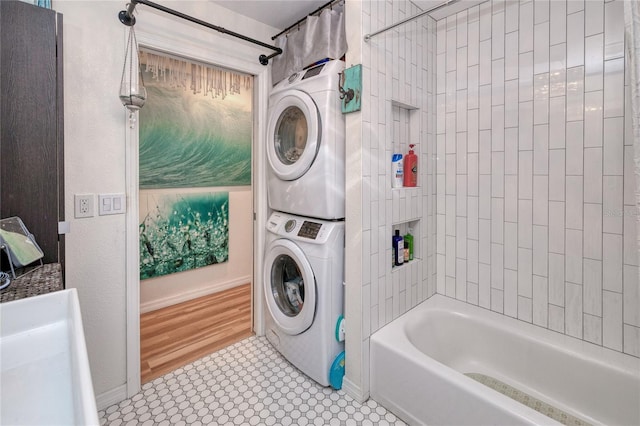 interior space with light hardwood / wood-style floors and stacked washing maching and dryer