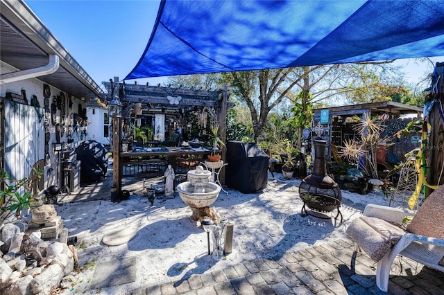 view of patio / terrace with a pergola and a fire pit