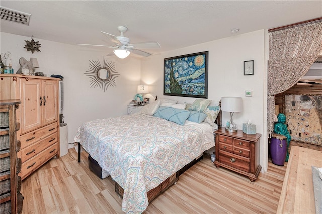 bedroom with ceiling fan and light hardwood / wood-style flooring